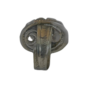 Tibetan silver ring with intricate design on a gray background