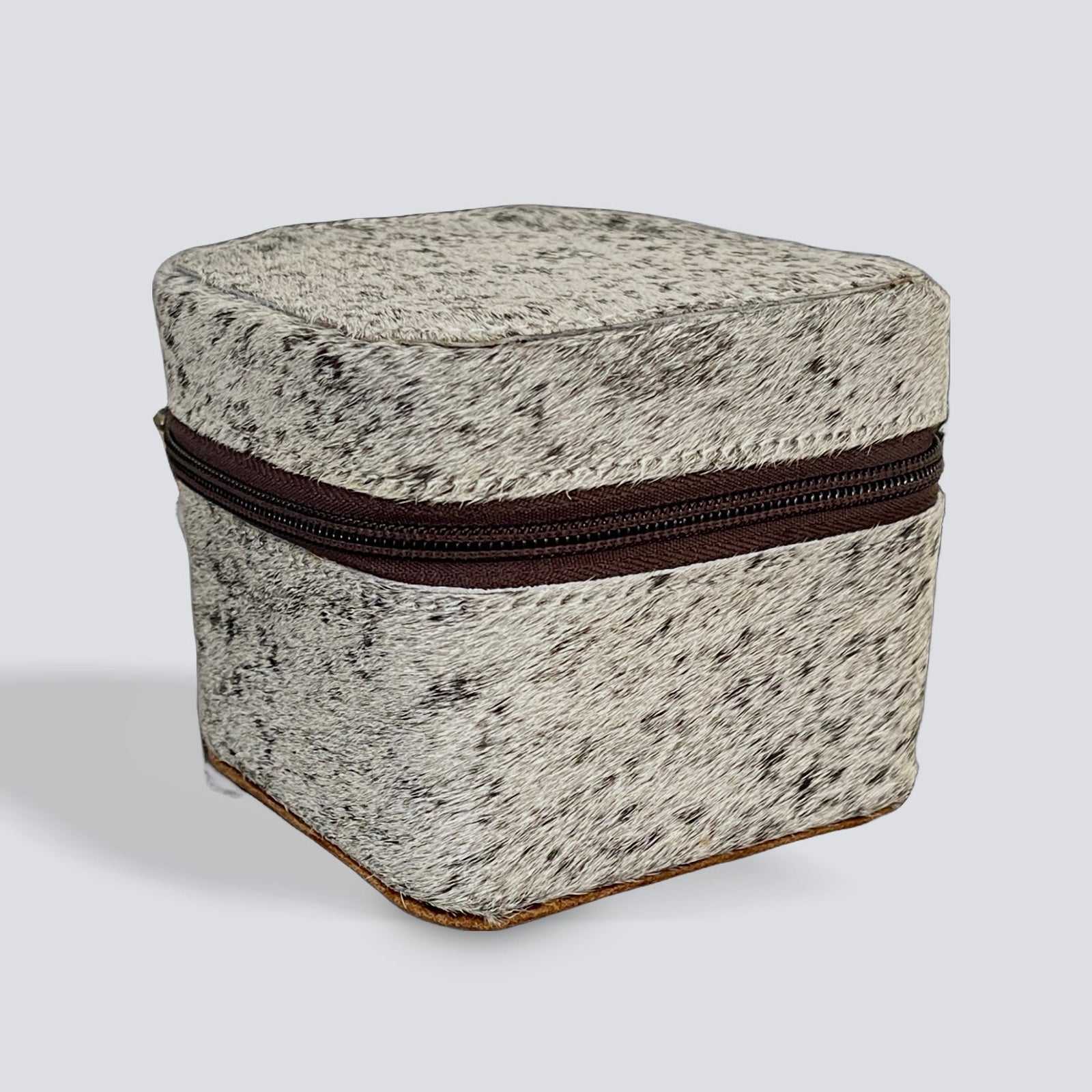 Speckled greige container with a dark chocolate brown speckled zipper on a light gray background